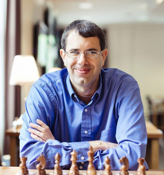 Keaton Kiewra sits in front of chess board